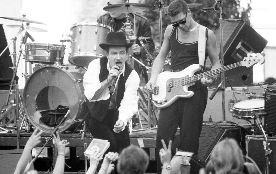 Nov. 11, 1987: U2 singer Bono and bassist Adam Clayton entertain San Franciscans during a free concert in San Francisco’s Justin Herman Plaza. The concert — and Bono's spray painting of the Vaillancourt Fountain — showed up in the movie “Rattle and Hum.” Photo: Fred Larson / The Chronicle / ONLINE_YES
