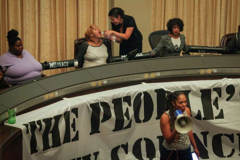 Protesters hold a “People’s Council” after taking over the Oakland City Council chambers Tuesday night. Photo: Sam Wolson / Special To The Chronicle / ONLINE_YES