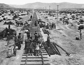 Track work takes place in Nevada as Central Pacific forces build the western link of the first transcontinental railroad, now a part of the Southern Pacific system, on May 10, 1868. Rail layers shown in the foreground were followed by groups of Chinese laborers who spaced and spiked the rail to the ties.