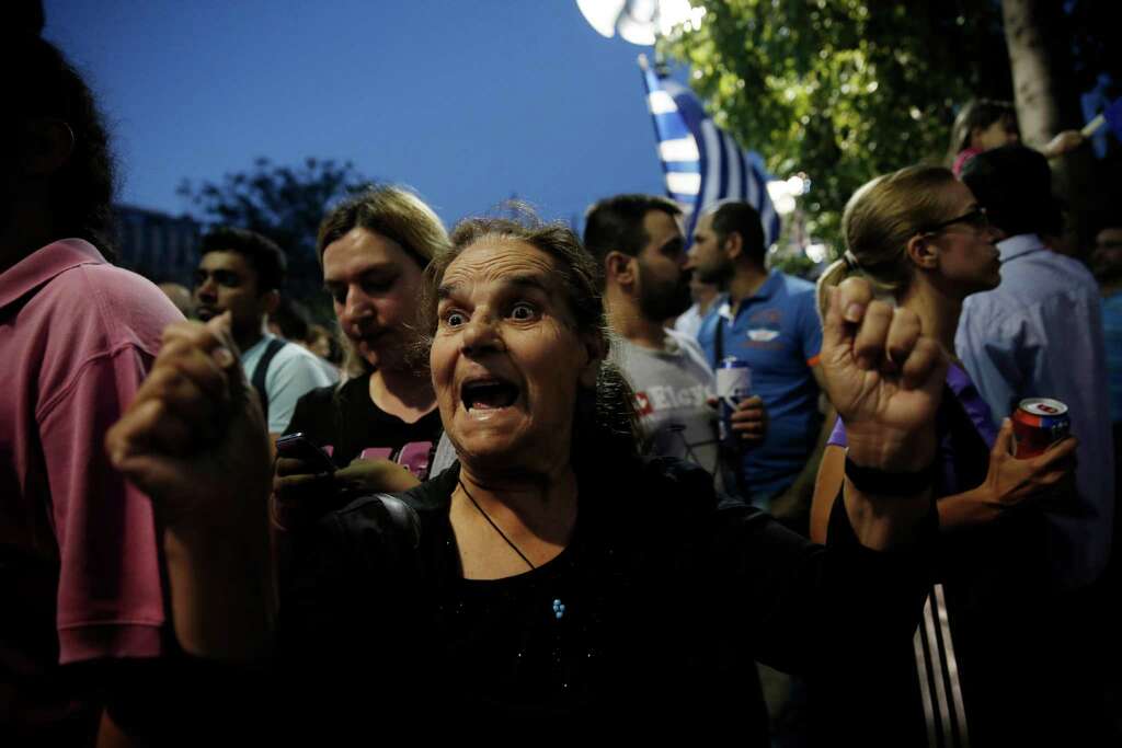 A supporter of the “no” vote expresses her enthusiasm. Meanwhile, Germany’s economy minister said Greeks have “torn down the last bridges” to compromise. Photo: Petros Giannakouris /Associated Press / AP