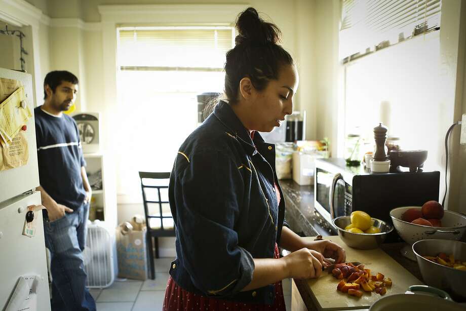 Stephany Gocobachi (right) and Akhil Khadse of S.F. company Flour Child make a small batch of their Peach Jam. Photo: Russell Yip, The Chronicle