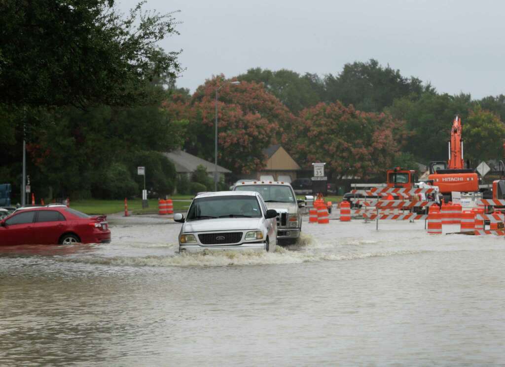 Trucks pass through high water on Fondren Road near the Southwest Freeway Sunday, Oct. 25, 2015, in Houston. Heavy rains moved into the area over night dropping four to nine inches of rain across parts of Harris County. Photo: Jon Shapley, Houston Chronicle / © 2015  Houston Chronicle