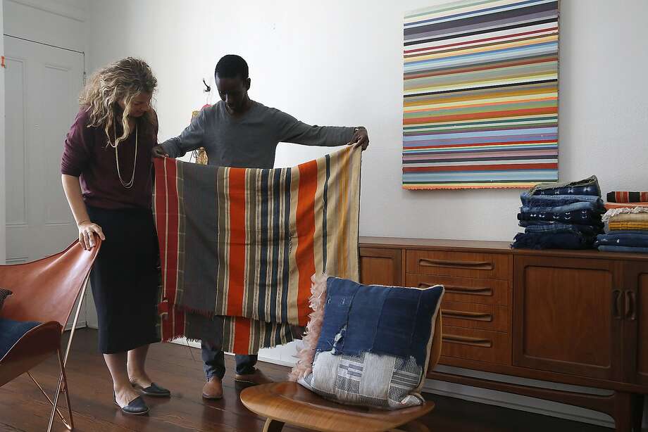 Petel founders Julie and Ibrahima Wagne show his great-grandmother’s blanket at home in San Francisco. Photo: Liz Hafalia, The Chronicle