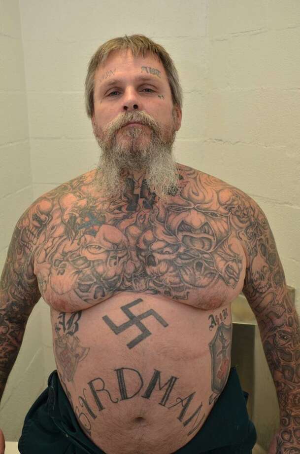Authorities call James Byrd a kingpin in the Aryan Brotherhood of Texas. Prosecutors described the gang-related markings on his body: "He has three ABT “patches,” one on each side of his abdomen and one on his calf, multiple swastikas, and additional Nazi symbols. Some of the more prominent links to white supremacy were David Lane’s “14 words”1 written out on his side, a poem about the Brotherhood on the other side, the Roman numerals I and II (standing for A [Aryan] and B [Brotherhood], the first and second letters of the alphabet) on his eyelids, and a roughly 20-inch depiction of Adolf Hitler on his back." He also had "a scalp covered in tattoos: a scorpion going up the back of his neck with its claws pointing to “1488” (the “14 spoken words” by David Lane and “88” for “Heil Hitler”—H being the eighth letter of the alphabet) and the stinger going around his neck and up his chin."