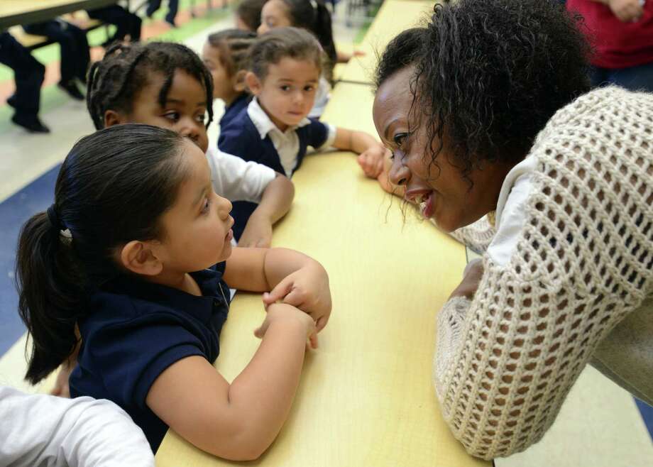 Designer Tracy Reese talks fashion with pre-k student Cassandra Santoyo Friday, Nov. 20, 2015, at Barnum School in Bridgeport, Conn. Reese was viting her adopted Turnaround Arts school to brainstorm with kids on a design project to enhance their school uniform. Photo: Autumn Driscoll / Hearst Connecticut Media / Connecticut Post