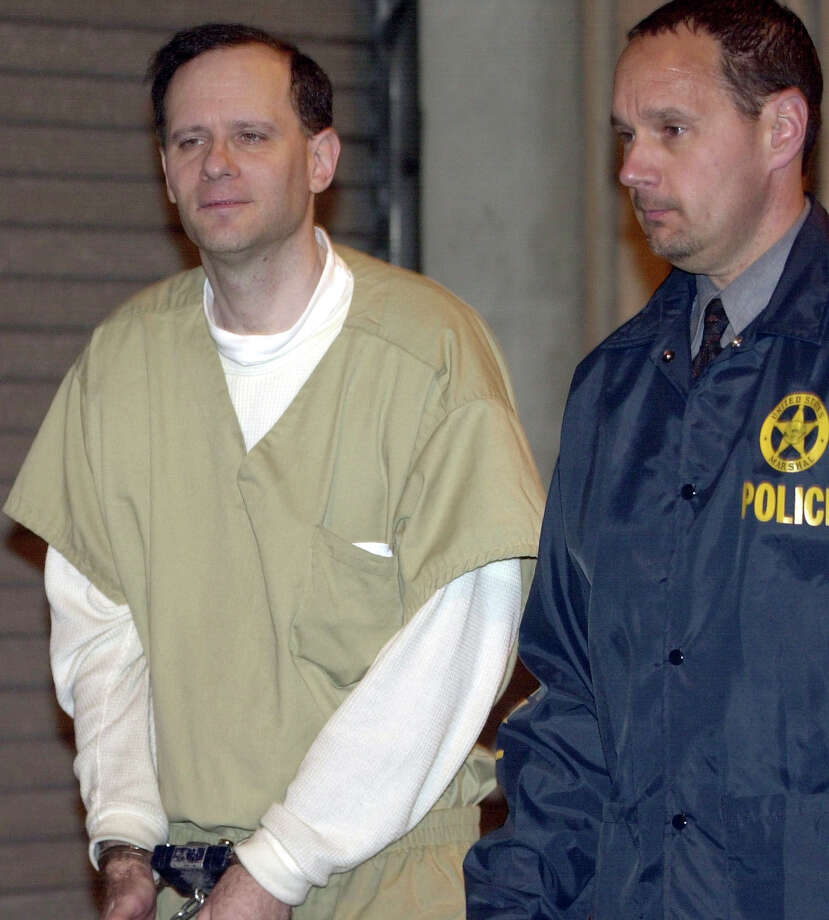 FILE - In this May 15, 2002 file photo, Martin Frankel, a financier accused of stealing more than $200 million from insurance companies, is escorted from U.S. District Court in New Haven, Conn. Frankel was sentenced in 2004 to 17 years behind bars, and released to a halfway house in September 2015. Frankel is due back in New Haven federal court Thursday, Oct. 1, 2015, less than a month after getting out of prison, charged with violating the terms of his release. (AP Photo/Bob Child, File) Photo: Bob Child / Associated Press / AP