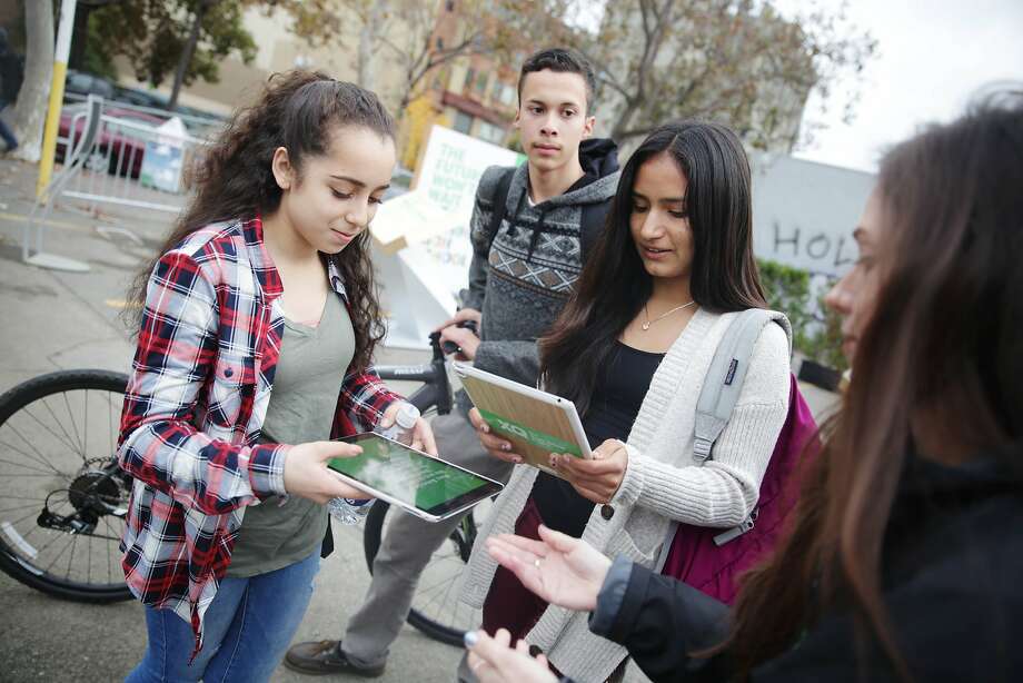 Melissa Iglesias (l to r), 15; Abel Regalado, 16; and Vanessa Martinez, 15, all students at ARISE High School register at the XQ roadshow on Wednesday, December 9,  2015 in Oakland, Calif. Photo: Lea Suzuki, The Chronicle