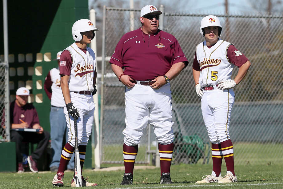 Harlandale baseball coach Eric Forestier (center) talks with John Navarro (right) and Robert Palomino at their opening game with Central Catholic on Feb. 25. Photo: Marvin Pfeiffer /San Antonio Express-News / Express-News 2016