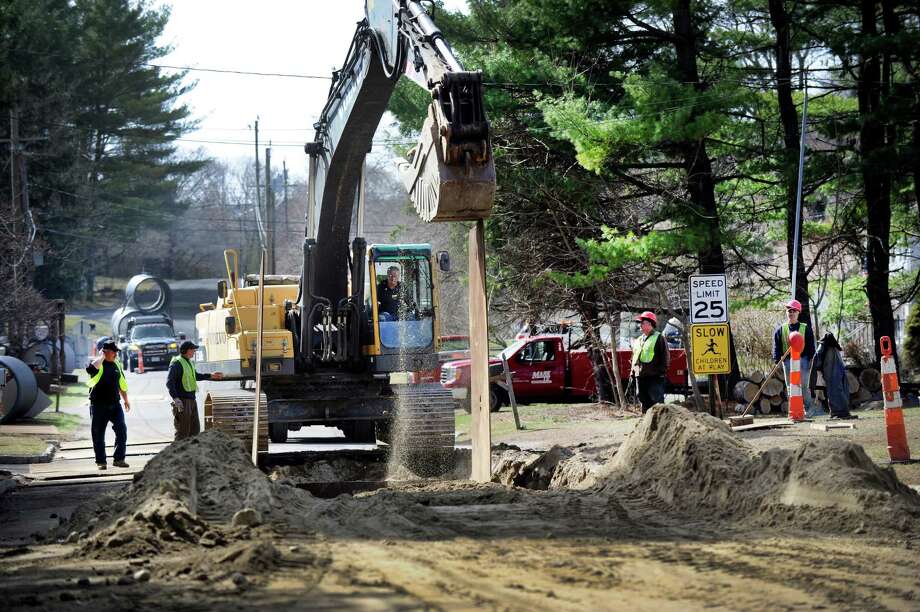 Workers are digging trenches on Meadowbrook Road near Birch Road in Brookfield on Wednesday. Flood remediation work has begun at the Meadowbrook Manor housing development that has, for years, been plagued with flooding from nearby Limekiln Brook. Photo: Carol Kaliff / Hearst Connecticut Media / The News-Times
