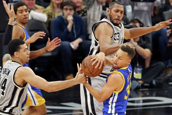 San Antonio Spurs' Danny Green and Boris Diaw defend Golden State Warriors' Stephen Curry during first half action Saturday March 19, 2016 at the AT&T Center.