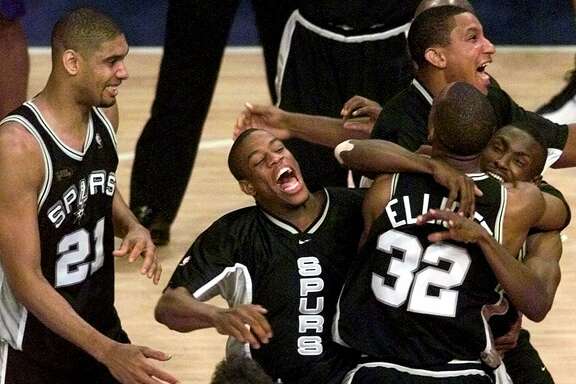 Spurs, from left, Tim Duncan, Antonio Daniels, Gerard King, Sean Elliott, and Avery Johnson celebrate after defeating the New York Knicks 78-77 in Game 5 of the 1999 NBA Finals on, June 25, 1999, at New York’s Madison Square Garden.