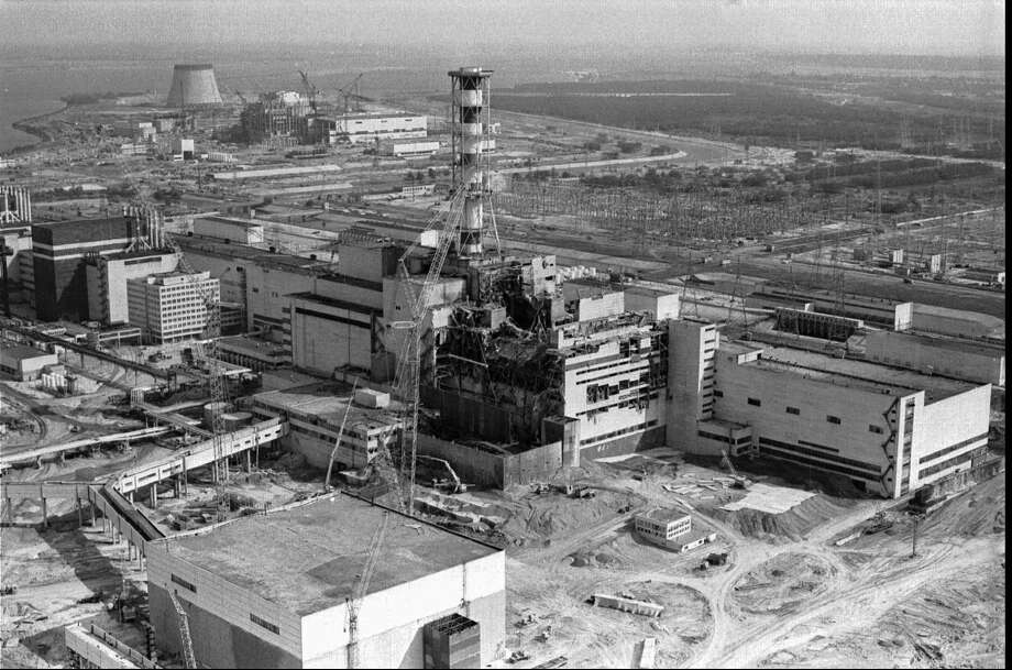 FILE - A 1986 file photo of an aerial view of the Chernobyl nuclear plant in Chernobyl, Ukraine showing damage from an explosion and fire in reactor four on April 26, 1986 that sent large amounts of radioactive material into the atmosphere. Telling the story of Chernobyl in numbers 30 years later involves dauntingly large figures and others that are even more vexing because they're still unknown. (AP Photo/Volodymyr Repik, File) ORG XMIT: LON27 Photo: Volodymyr Repik / AP