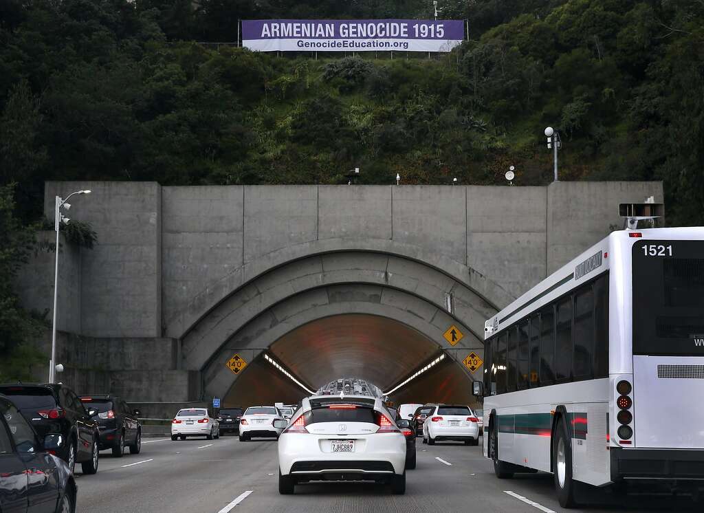 Bay Bridge commuters approach the Yerba Buena Island tunnel below a large banner about Armenian genocide in San Francisco, Calif. on Wednesday, April 27, 2016. Photo: Paul Chinn, The Chronicle