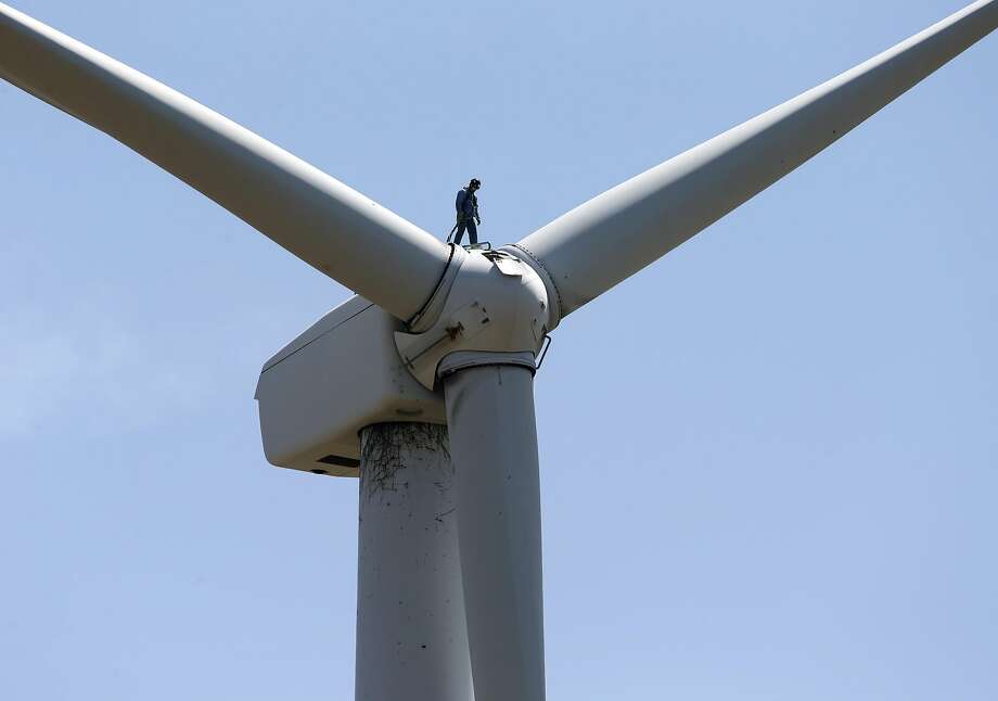 Steven Kadel performs maintenance work on top of a wind turbine 80 