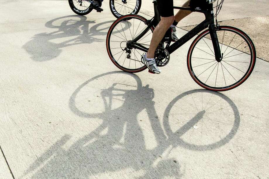 Cyclist cast their shadows on the race course during the Memorial Hermann Ironman North American Championship Texas triathon on Saturday, May 14, 2016, in The Woodlands. Photo: Brett Coomer, Houston Chronicle / © 2016 Houston Chronicle