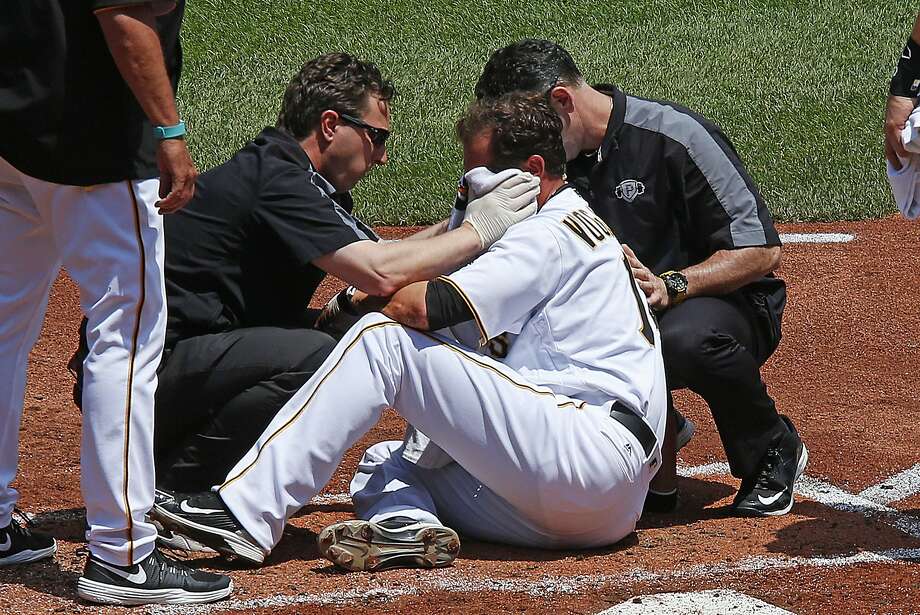 Pittsburgh Pirates pitcher Ryan Vogelsong, center, is helped by team trainers after being hit in the head by a pitch from starting pitcher Jordan Lyles in the second inning of a baseball game in Pittsburgh, Monday, May 23, 2016. The Pirates won 6-3. (AP Photo/Gene J. Puskar) Photo: Gene J. Puskar, Associated Press