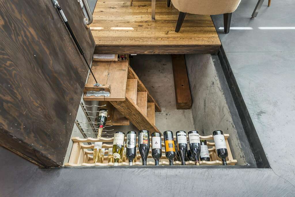 Lifting floorboards in the great room's dining area reveals a wine cellar. Photo: Olga Soboleva / Vanguard Properties