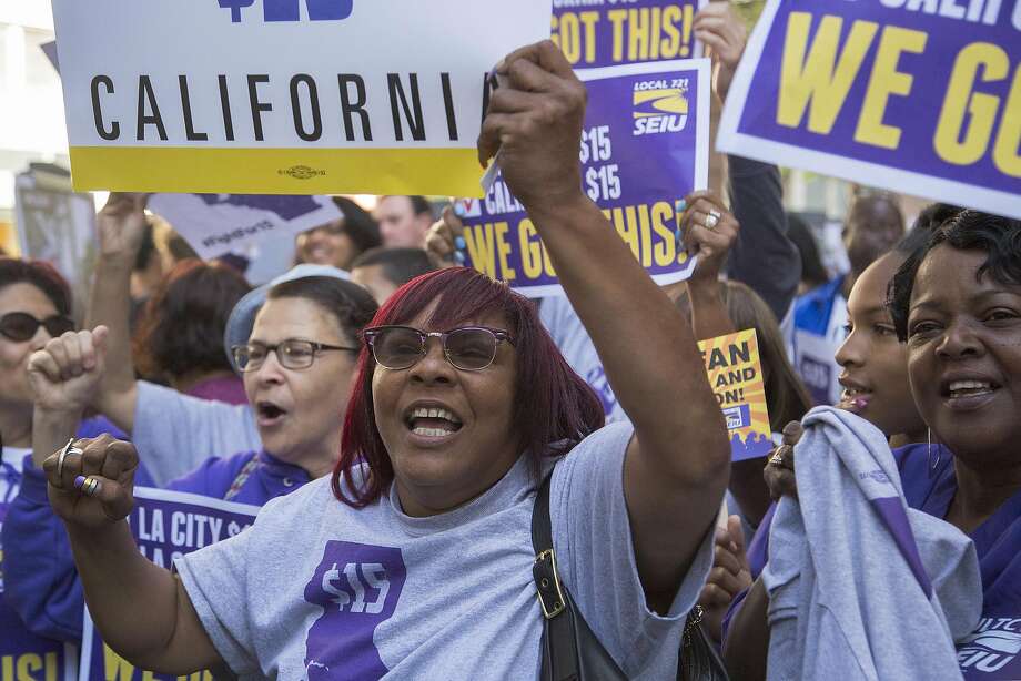 LOS ANGELES, CALIFORNIA - APRIL 04:  Service Employees International Union members celebrate after California Governor Jerry Brown signed landmark legislation SB 3 into law on April 4, 2016 in Los Angeles, California. The law makes California the first state in the nation to commit to raising the minimum wage to $15 per hour statewide. (Photo by David McNew/Getty Images) Photo: David McNew, Getty Images