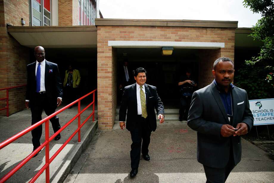 New Houston Independent School District Superintendent Richard Carranza, center, leaves Yates High School on his way to his next stop as he visits schools around the district for the first day of school Monday, August 22, 2016 in Houston. Photo: Michael Ciaglo, Houston Chronicle / © 2016  Houston Chronicle
