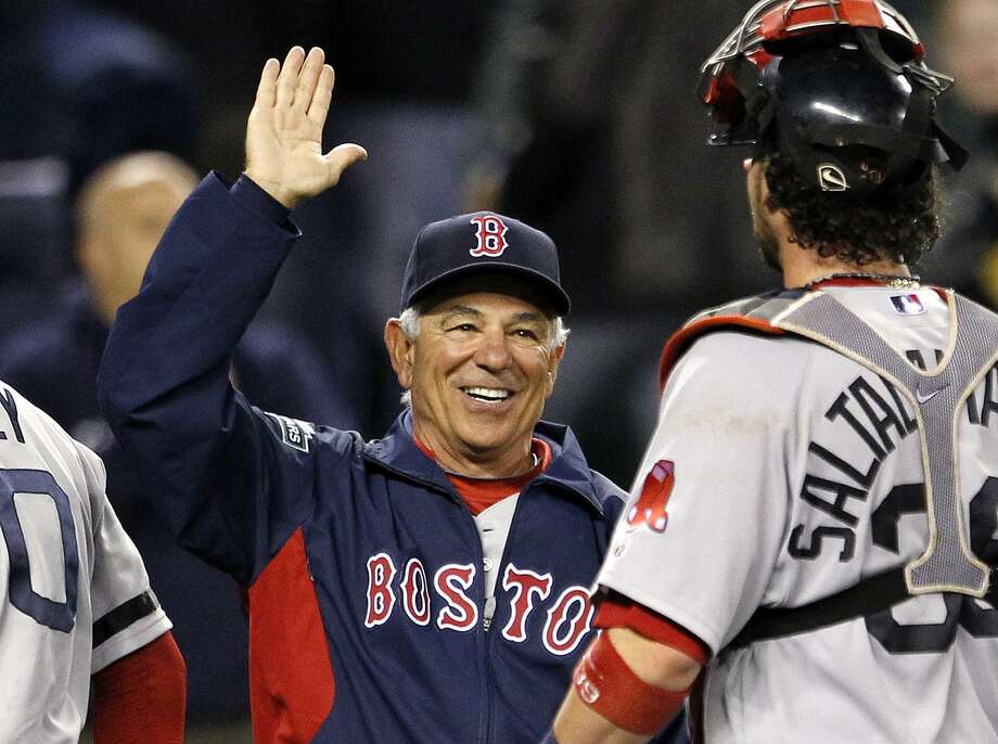 Boston Red Sox manager Bobby Valentine, left, greets catcher Jarrod Saltalamacchia after the team beat the Seattle Mariners in a baseball game Tuesday, Sept. 4, 2012, in Seattle. The Red Sox won 4-3. (AP Photo/Elaine Thompson) Photo: Elaine Thompson / ASSOCIATED PRESS / AP2012