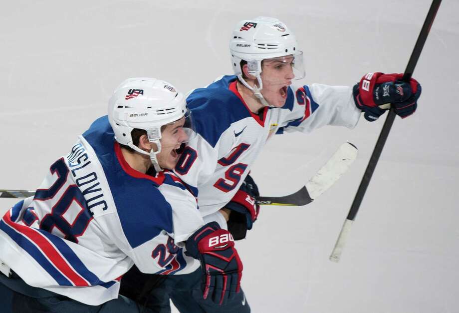 FILE - In this Jan. 4, 2017, file photo, United States' Troy Terry, right, celebrates with teammate Jack Roslovic after scoring in a shootout to defeat Russia 4-3 in a semifinal at the World Junior ice hockey championships in Montreal. If the likes of Patrick Kane, Jonathan Quick, Jack Eichel and Ryan Suter aren’t available for the 2018 Winter Olympics, USA Hockey will look mostly to the college ranks. (Paul Chiasson/The Canadian Press via AP, File) ORG XMIT: NY157 Photo: Paul Chiasson / The Canadian Press