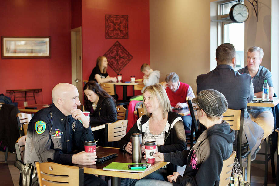 BRITTNEY LOHMILLER | blohmiller@mdn.netMidland residents Gwen Malone, center, and Stephanie Thomas, right, chat with Midland Police Chief Clifford Block at Coffee Chaos Thursday morning during the first Coffee with a Cop. / Midland Daily News