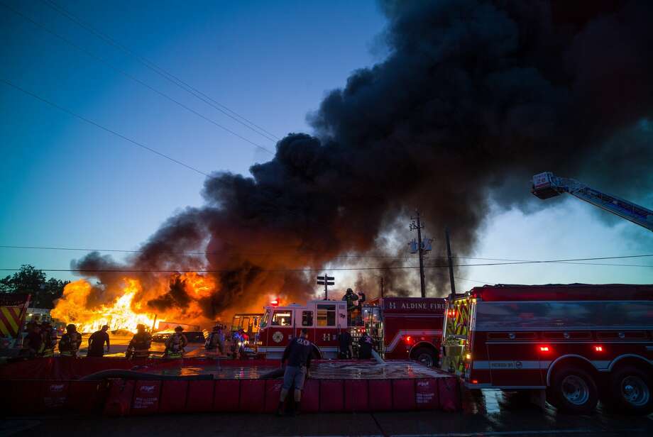 Local firefighters overlook a blaze that engulfed Charlie's Bar-B-Q restaurant in the 8200 block of Airline Drive in Houston, Texas on May 4, 2017. Photo: Godofredo A. Vasquez/Houston Chronicle