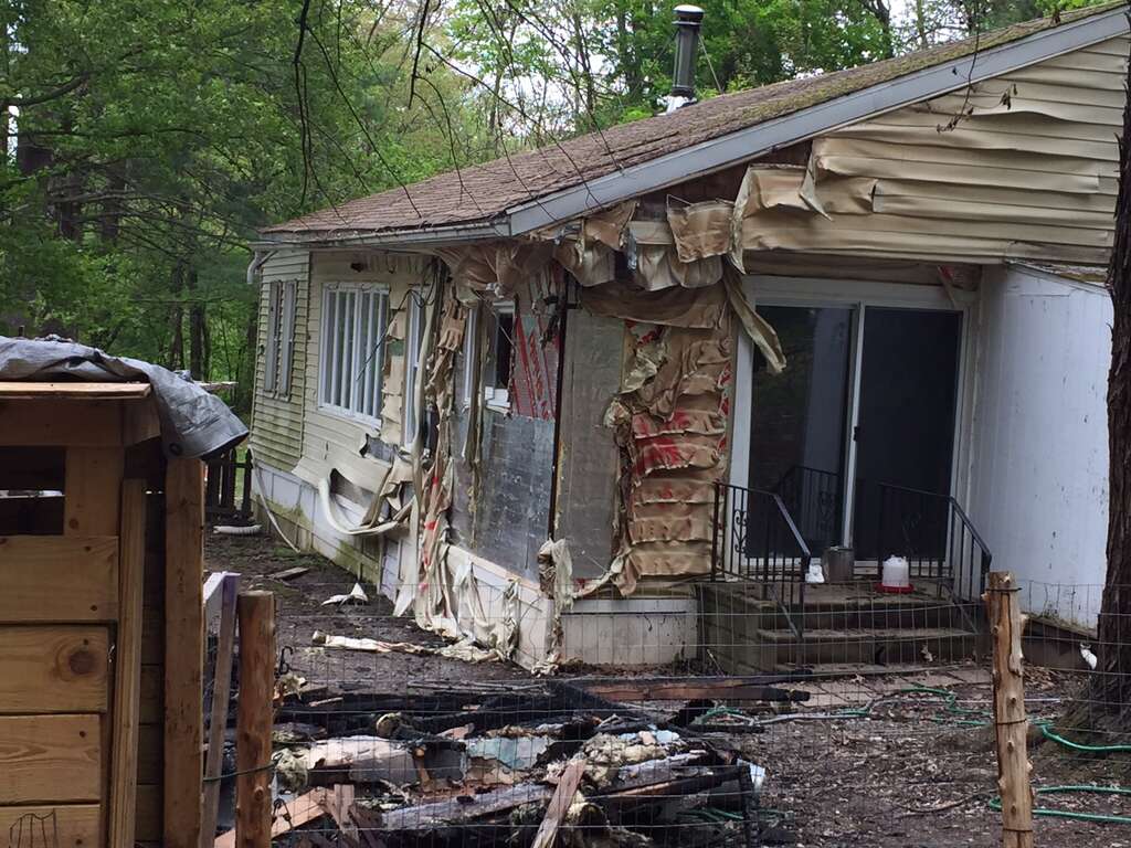 A black family woke up Sunday night to find their detached garage sprayed with hateful graffiti and engulfed in flames, Schodack Police Chief Joseph Belardo said Monday, May 15, 2017. The parents and their five children — who are all under the age of 10 — were physically unharmed but emotionally traumatized by the fire set at 29 Cold Spring Ave., the chief said. (Robert M. Gavin/Times Union) Photo: Robert Gavin