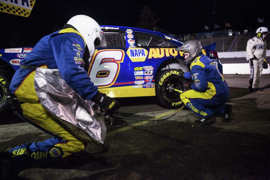 SPOKANE, WA - MAY 13: Members of Todd Gilliland #16 pit crew work to change tires and prepare the vehicle for the second half during the NAPA Auto Parts 150 at Spokane County Raceway on May 13, 2017 in Spokane, Washington. Todd Gilliland finished first, followed by Derek Kraus and Chris Eggleston. (Photo by Lindsey Wasson/Getty Images for NASCAR) ORG XMIT: 700046968 Photo: Lindsey Wasson / 2017 Getty Images