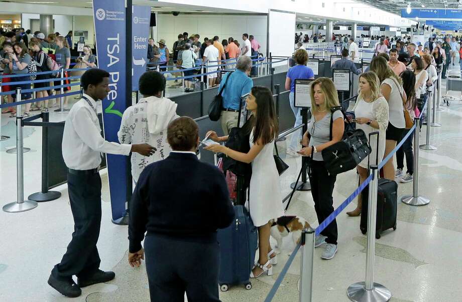 In this Friday, May 27, 2016, photo, travelers stand in line as they prepare to be screened at a Transportation Security Administration checkpoint at Fort Lauderdale-Hollywood International Airport in Fort Lauderdale, Fla. By air or car, summer 2017 travel numbers are expected to rise over the previous year thanks to deals on airfares and stable gasoline prices. (AP Photo/Alan Diaz) ORG XMIT: NYBZ530 Photo: Alan Diaz / Copyright 2016 The Associated Press. All rights reserved. This m