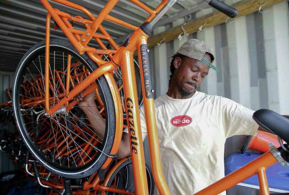 Alan Moore, co-founder of 3rd Ward Tours, moves bicycles from their storage container Sunday. The bicycle tour company has 20 new bicycles for group tours in the community. Photo: Yi-Chin Lee, Staff / © 2017 Houston Chronicle