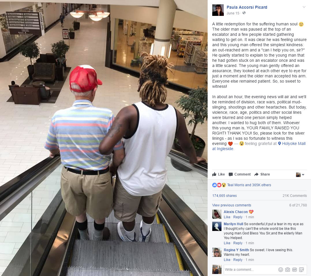 Stranger helps frightened elderly man onto escalator and rides down with him arm-in-arm