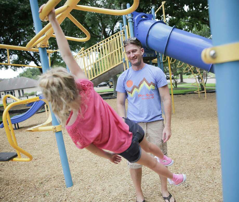 Ben Andrews watches his daughter, Addison, 8, as she plays on a swing set on Thursday, July 20, 2017, in Pearland. Andrews, 38, was diagnosed with the same type of brain cancer Sen. John McCain has almost 2 years ago. Photo: Elizabeth Conley, Houston Chronicle / © 2017 Houston Chronicle