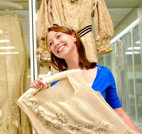Meaghan Gorman 21 holds a wedding dress from 1929 while