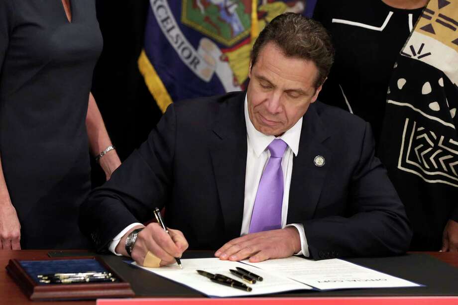 FILE- In this April 4, 2016 file photo, New York Gov. Andrew Cuomo signs a law that will gradually raise New York's minimum wage to $15, at the Javits Convention Center, in New York. New York joins 18 other states by raising its minimum wage in 2017. (AP Photo/Richard Drew, Pool, File) Photo: Richard Drew / Copyright 2016 The Associated Press. All rights reserved. This m