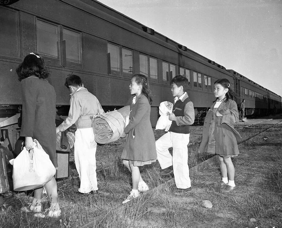Japanese American children from the Tanforan internment camp in San Bruno board a train for a camp in Utah in 1942. Photo: Chronicle File Photo, The Chronicle