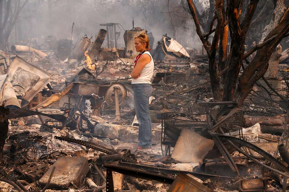 Terrie Burns stands in the middle of her destroyed at the scene of the Tubbs Fire in Santa Rosa, Ca., on Monday October 9, 2017. Massive wildfires ripped through Napa and Sonoma counties early Monday, destroying hundreds of homes and businesses on Monday October 9, 2017 Photo: Michael Macor, The Chronicle