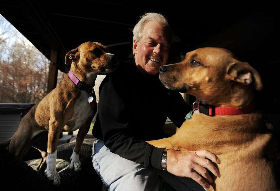 Jerry plays with his pet dogs, who were rescued from area shelters, at his Bridgeport-area home, on Tuesday, Nov. 21, 2017. Photo: Brian A. Pounds / Hearst Connecticut Media / Connecticut Post