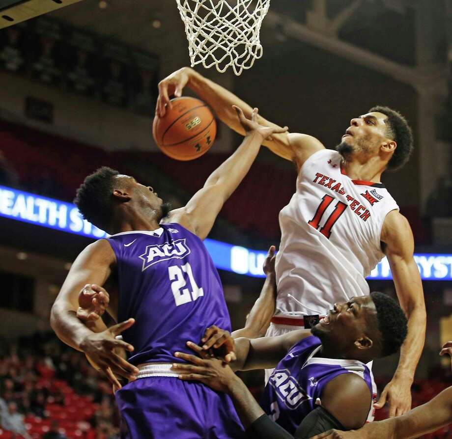 Texas Tech's Zach Smith, right, snatches a rebound away from Abilene Christian's Jalone Friday in the second half of Friday's game at Lubbock. Photo: Brad Tollefson, FRE / FR171432 AP