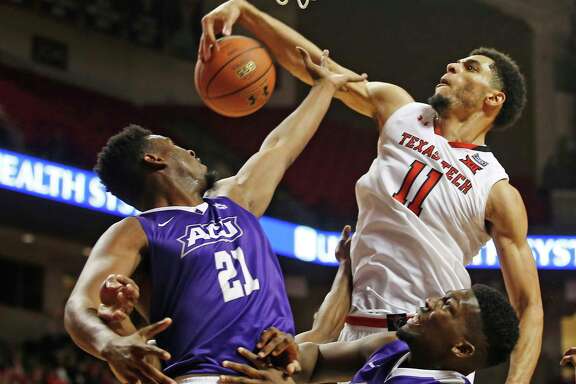 Texas Tech's Zach Smith, right, snatches a rebound away from Abilene Christian's Jalone Friday in the second half of Friday's game at Lubbock.
