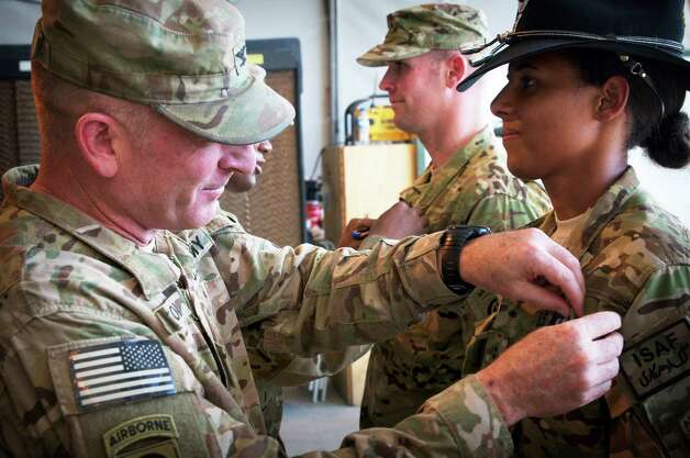PARWAN PROVINCE, Afghanistan - U.S. Army Col. T.J. Jamison, 82nd Combat Aviation Brigade commander, of Broken Arrow, Okla., awards U.S. Army Chief Warrant Officer 2 Thalia Ramirez, of Nairobi, Kenya, with the Air Medal Aug. 30, 2012, on Bagram Airfield, Afghanistan. Ramirez, an OH-58D Kiowa Warrior pilot assigned to Troop F, 1-17 Air Cavalry Regiment, 82nd Combat Aviation Brigade, 82nd Airborne Division, was killed when her helicopter crashed in Logar Province, Afghanistan, Sept. 5, 2012.  (U.S. Army photo by Sgt. 1st Class Eric Pahon) Photo: Sgt. 1st Class Eric Pahon, Courtesy / U.S. Army