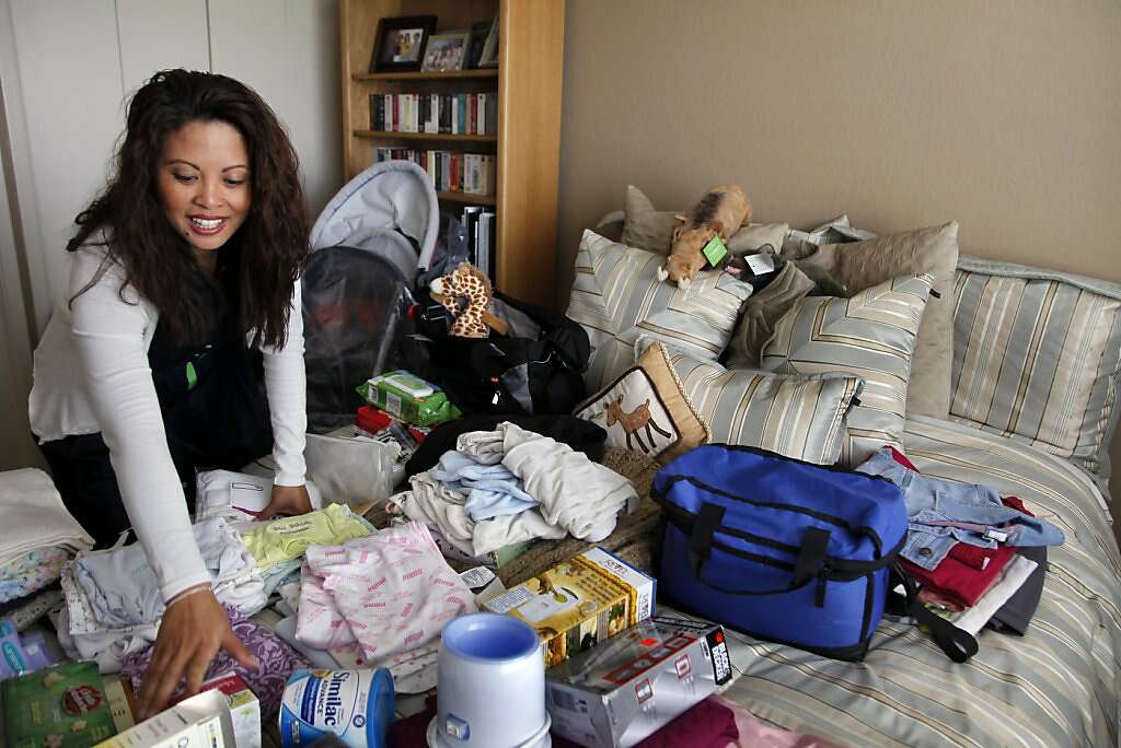 Jennifer Benito-Kowalski organizes baby supplies while packing for a 3 1/2-week trip to India in her San Carlos, Calif., home on Friday, May 17, 2013. After years of trying to conceive a child, the Kowalskis paid a surrogate in India to carry their child. Photo: Nicole Fruge, The Chronicle
