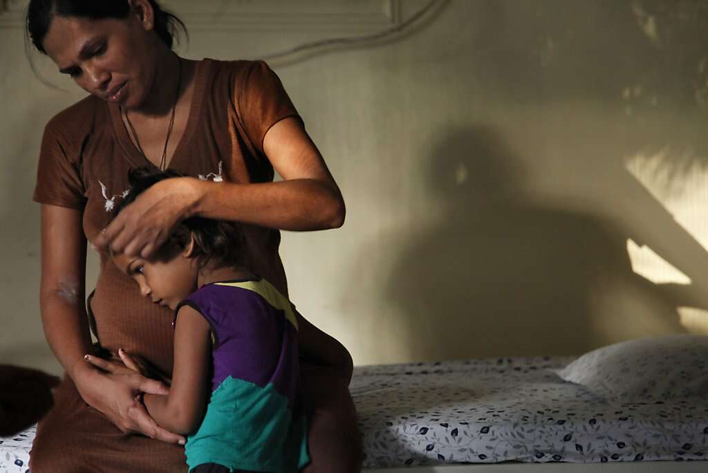 Surrogate Manisha Parmar comforts daughter Urvashi, 3, at the Akanksha Infertility Clinic, Wednesday, May 22, 2013, in Anand, India. Parmar gave birth the next day. Photo: Nicole Fruge, The Chronicle