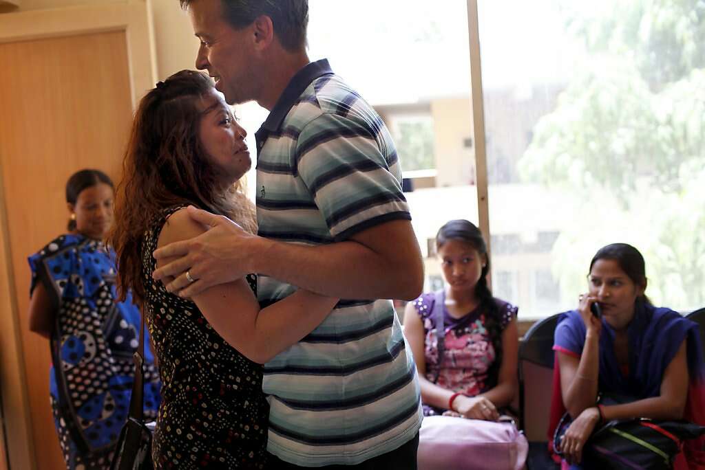 Jennifer Benito-Kowalski and Steve Kowalski embrace after learning that surrogate Manisha Parmar delivered a baby boy by cesarean section at the Akanksha Infertility Clinic in Anand, India, Thursday, May 23, 2013. Photo: Nicole Fruge, The Chronicle