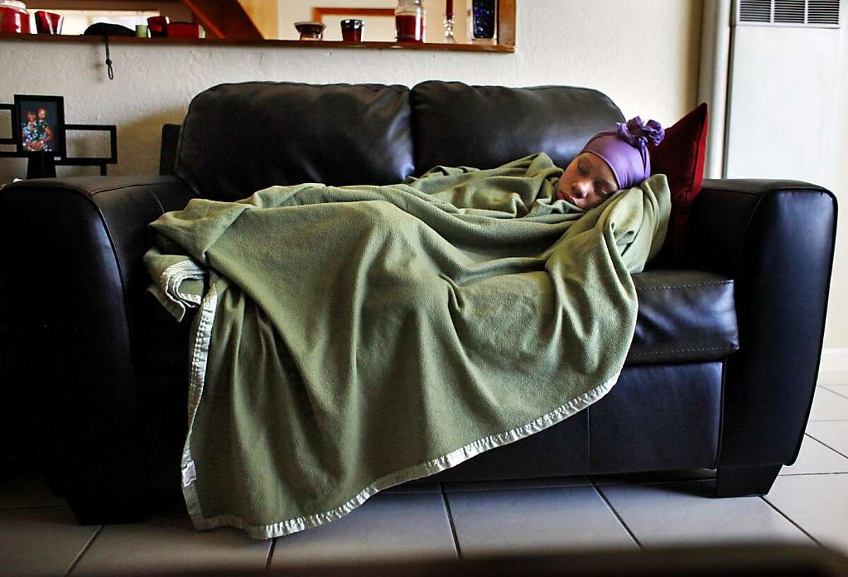 Brijjanna Price, 16, sleeps on the couch, Friday April 20, 2012, in her father's home in Antioch, Calif. The pregnant teenager suffers from depression and lack of motivation since the killing of her brother, Lamont Price, who was 17 when he was shot to death. Photo: Lacy Atkins, The Chronicle