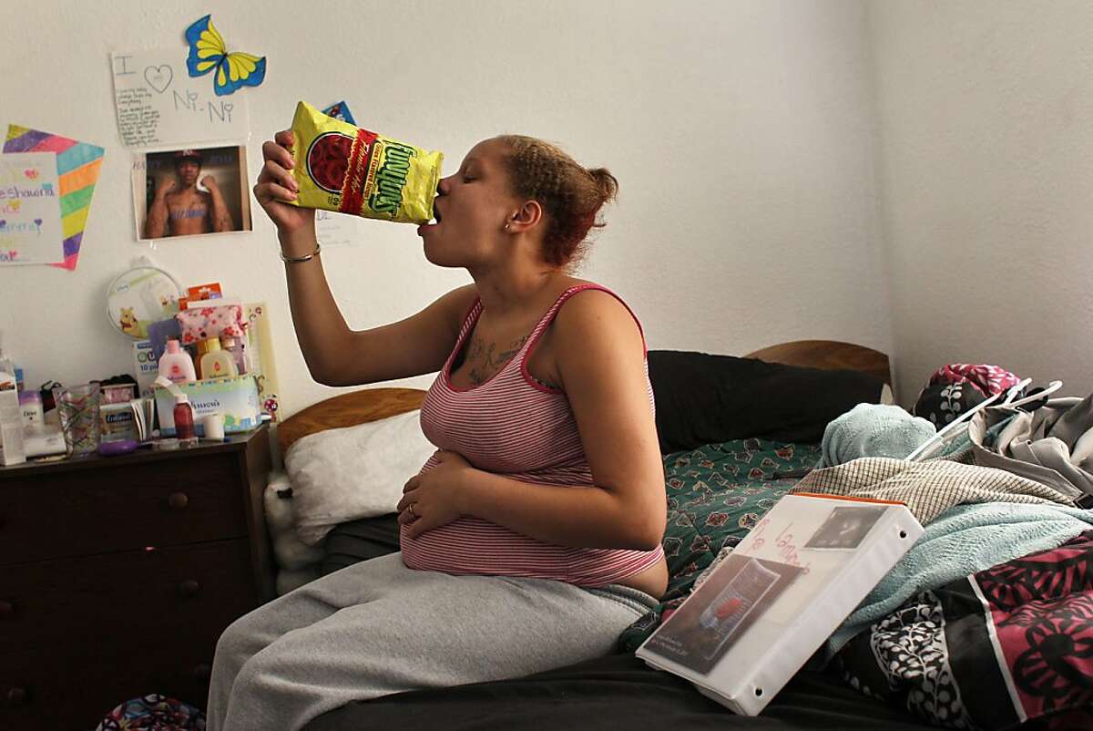 Brijjanna Price, 8 months pregnant , has a snack after school in her room on Oct. 8, 2012, at her godmothers house in Oakland, Calif. She named her baby La'Mya Deshana Price in memory of her brother Lamont was gunned down on February 16. Photo: Lacy Atkins, The Chronicle