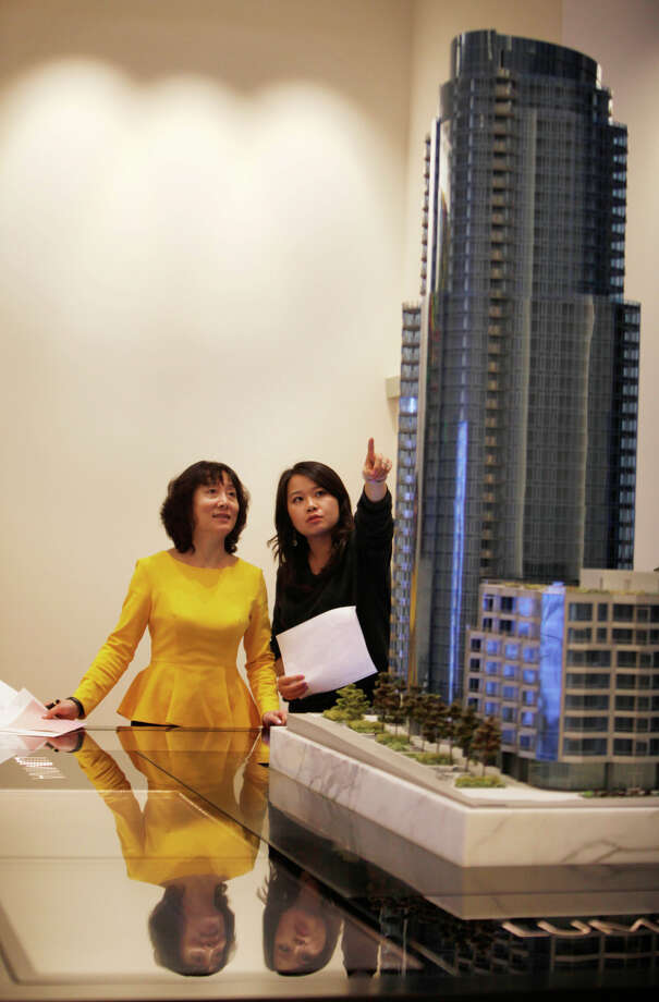 Lumina sales associate Yang Chen (right) talks with Donna Li of Mountain View, who may face foreign buyers with cash. Photo: Lea Suzuki / The Chronicle / ONLINE_YES