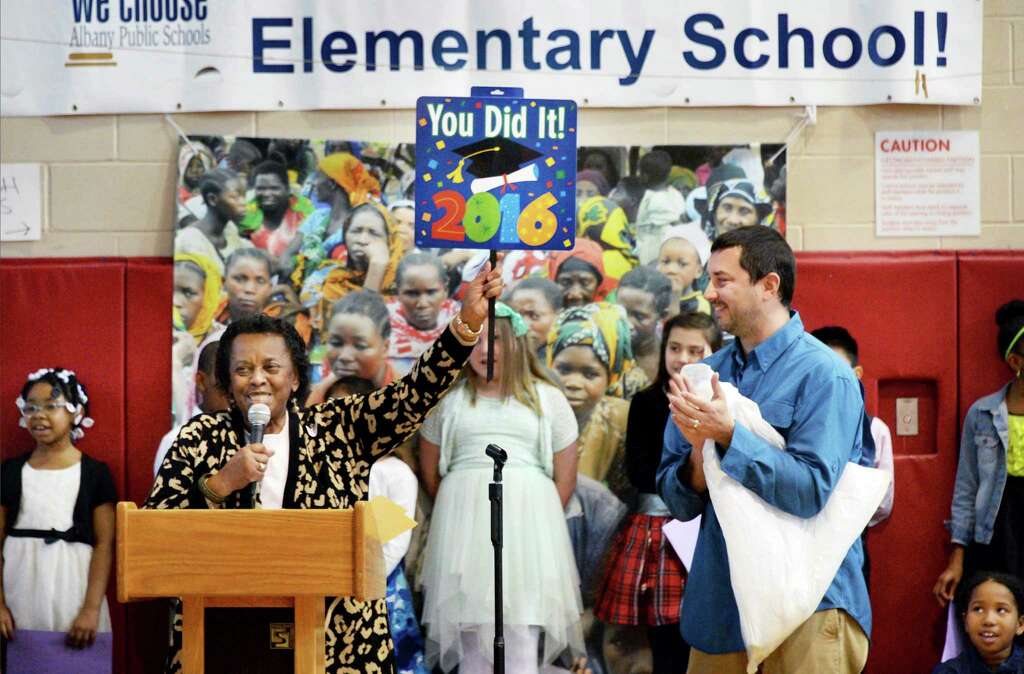 Jean Dobbs of African Reflections Foundation and Kevin Bailey, right,owner of High Peaks Solar thank students at Pine Hills Elementary who raised $15,000 to support a deep water well in rural Tanzania during a ceremony at the school Wednesday April 20, 2016 in Albany, NY. (John Carl D'Annibale / Times Union) Photo: John Carl D'Annibale / 10036266A