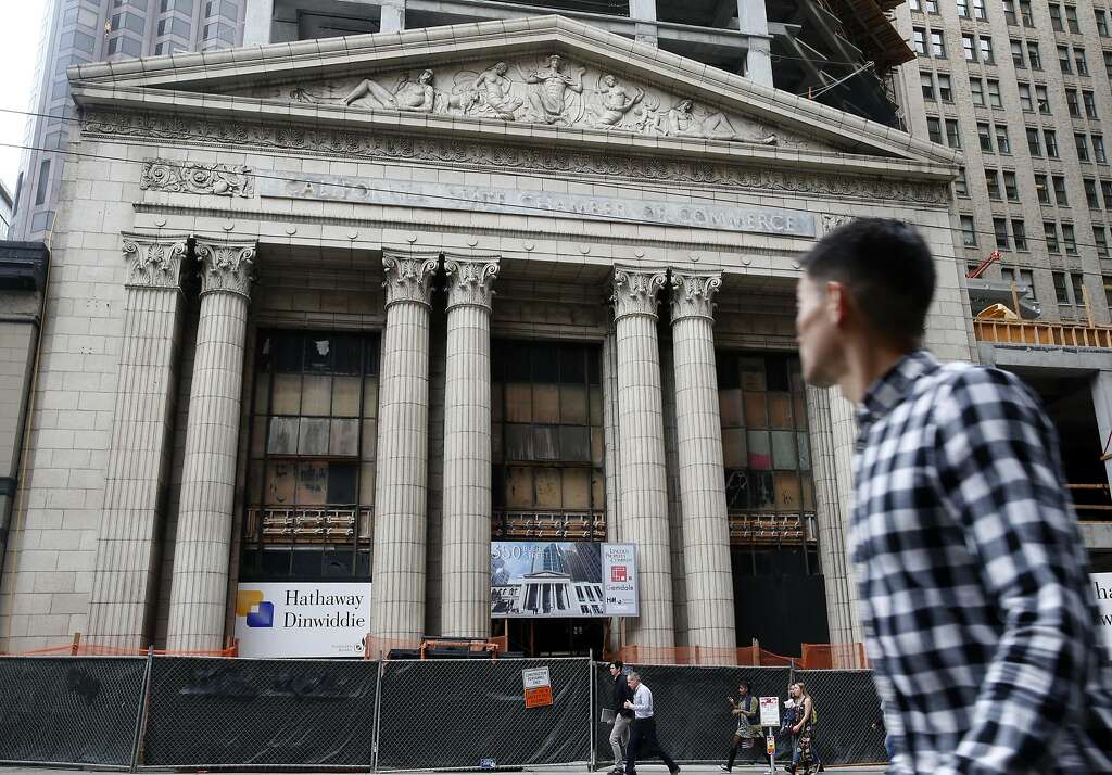 A man walks past the old Mining Exchange Building at 350 Bush Street where construction on a 19-story office tower continues in San Francisco, Calif. on Friday, Aug. 5, 2016. Photo: Paul Chinn, The Chronicle