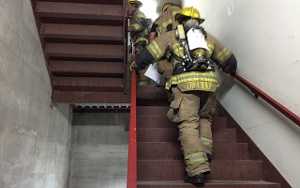Firefighter climbs 110 sets of stairs at gym, in full gear, to honor 9/11 first responders